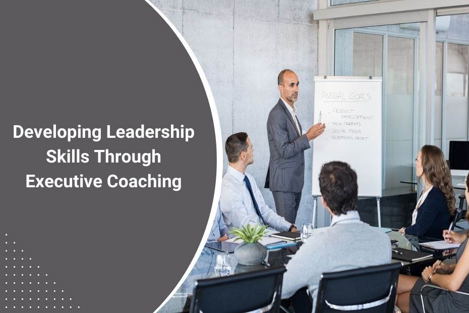 A professional executive coach guiding a business leader in a one-on-one coaching session to develop leadership skills.